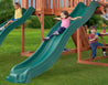Image shows small child sliding down ten foot green wave slide as additional children look on from the playset